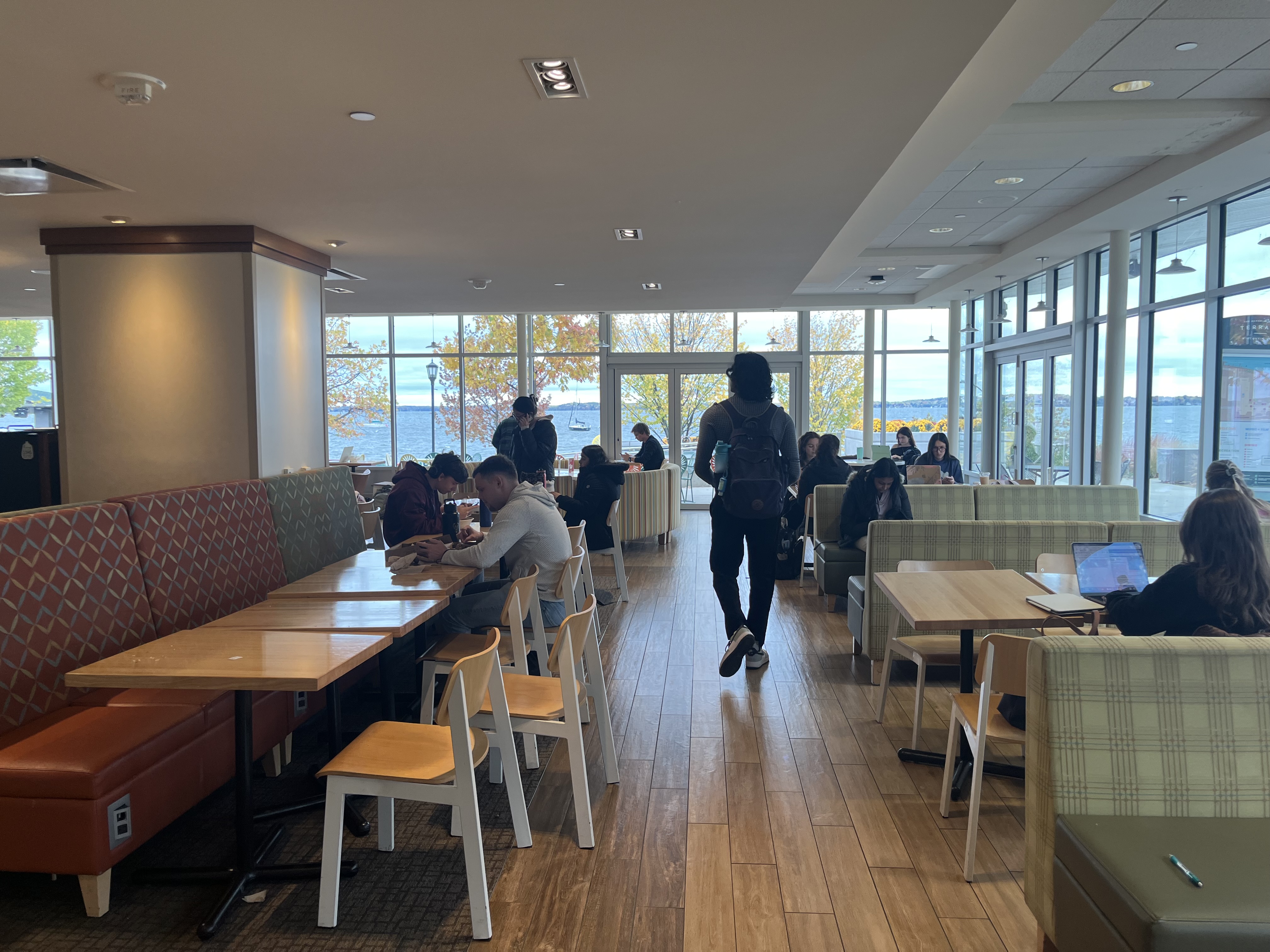 Many students study in Memorial Union with views of Lake Mendota in the Background.