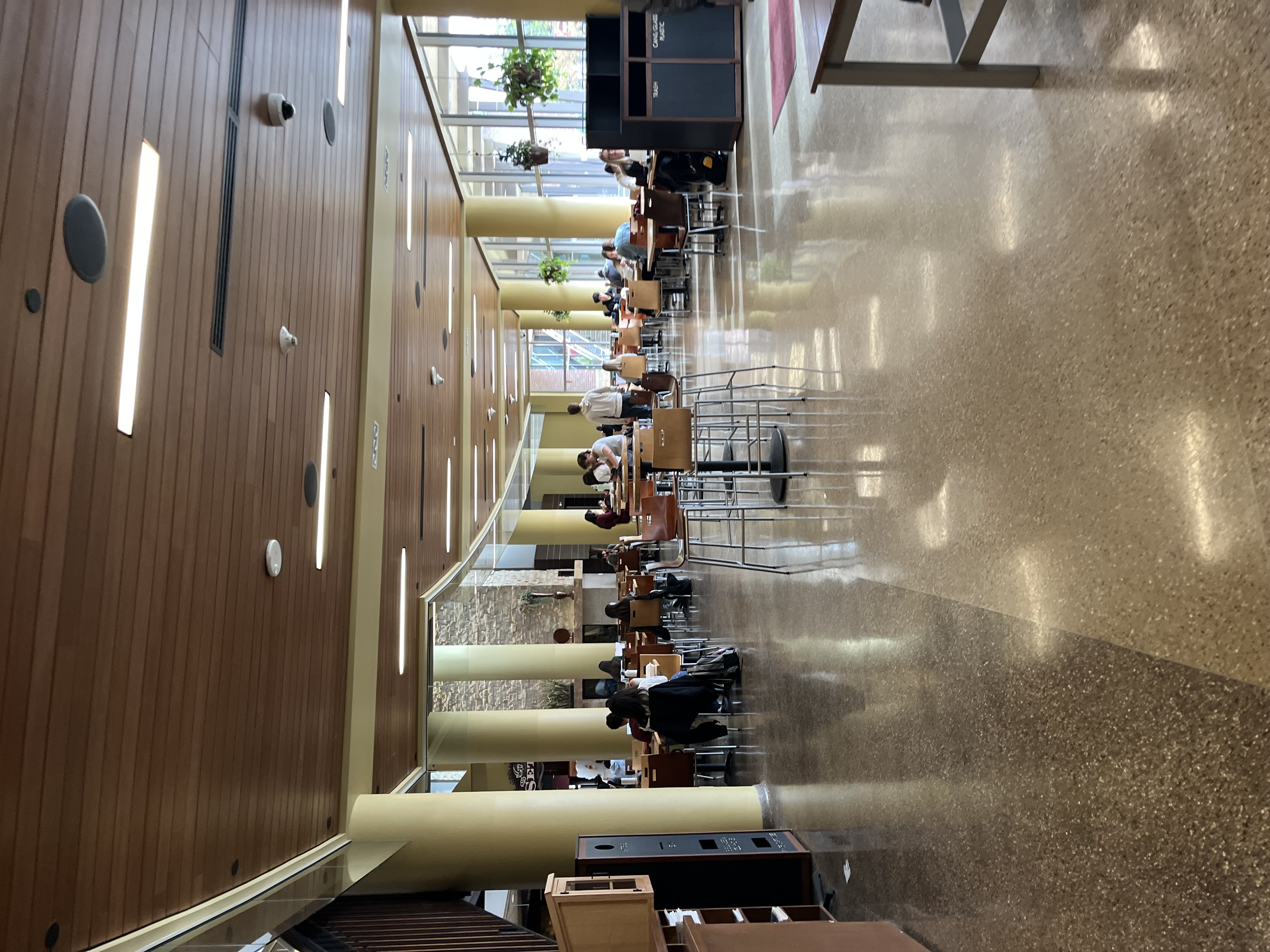 Union South large studying area with lots of natural light and many students studying.